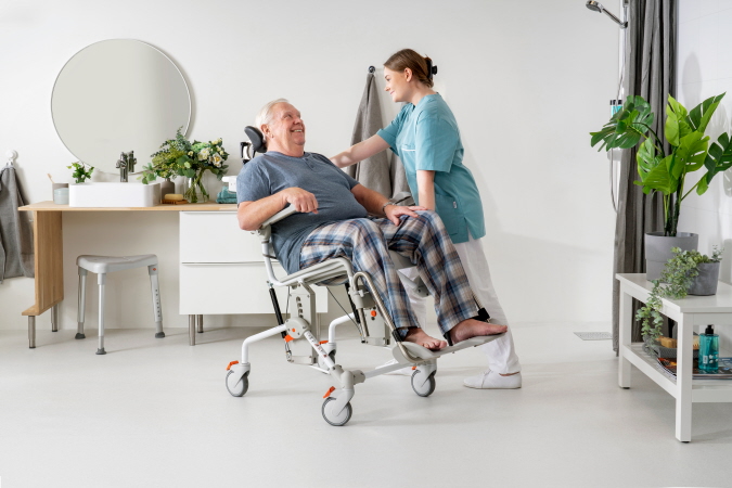 Etac Swift Mobil Tilt-2 XL user and carer (4).jpg